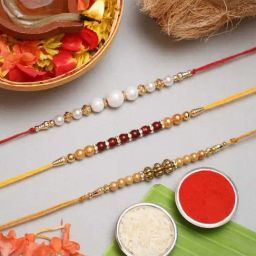 eCraftIndia White, Red & Golden Pearl Rakhis with Roli Chawal Pack - Set of 3-33