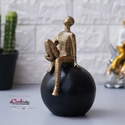 eCraftIndia Golden Polyresin  Boy Statue Sitting on Black Ball Showpiece-image-88