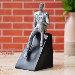 eCraftIndia Multicolor Polyresin  Man Statue Sitting on Triangle Black Base Human Showpiece-image-70