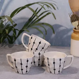 Myntra Elegant Homes Set of 4 Black Fairy Lights Off-white Ceramic Coffee Mugs-22