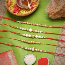 eCraftIndia White & Golden Pearl Rakhis with Roli Chawal Pack - Set of 5-13