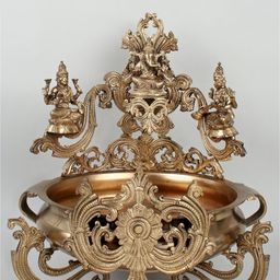 Exotic India Gold Toned Ganesha-Lakshmi-Saraswati Urli Pooja Diya-image-37