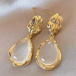 Celestria Gold-Plated Artificial Stones Studded Teardrop Shaped Drop Earrings-53