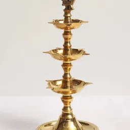 Exotic India Gold Toned Peacock Three-Layer Oil Lamp-image-50
