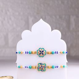 Floweraura Set Of 2 Floral Thread Rakhi With Sansevieria Plant & Roli Chawal-image-31