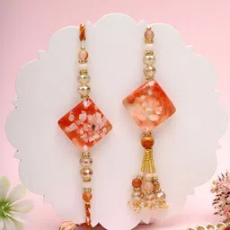 Myntra Elegant Homes Set Of 2 Amber Charm Rakhis & Greeting Card & Roli Chawal-image-30