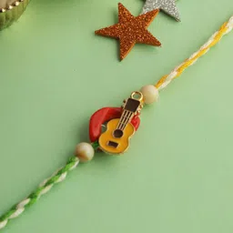 Aapno Rajasthan Cute Little Guitar Rakhi With Roli Chawal & Greetings Card-58